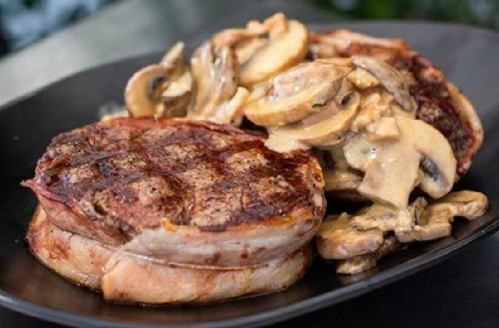 Bacon-wrapped filet mignon in red wine mushroom sauce