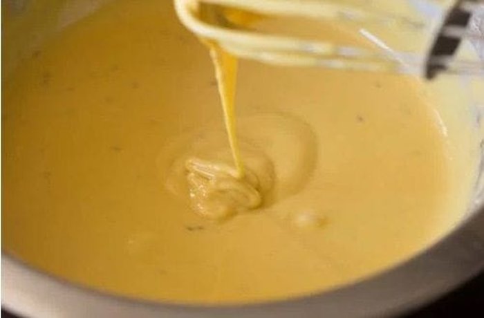 Batter of eggs, milk, and flour in a bowl for the cauliflower