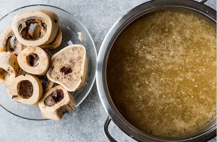 Beef bone broth simmering in a pot, the base of the Chilean machos ahogados soup