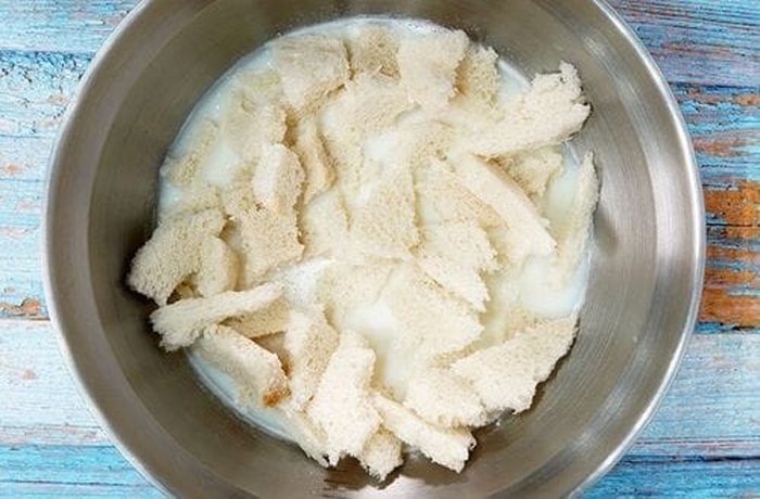 White bread soaking in milk to soften it for the Chilean zucchini loaf.