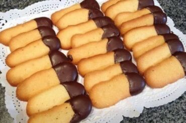 Thin cat tongue cookies with one end dipped in dark chocolate