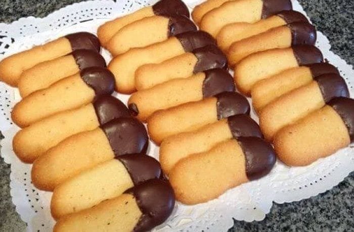 Thin cat tongue cookies with one end dipped in dark chocolate