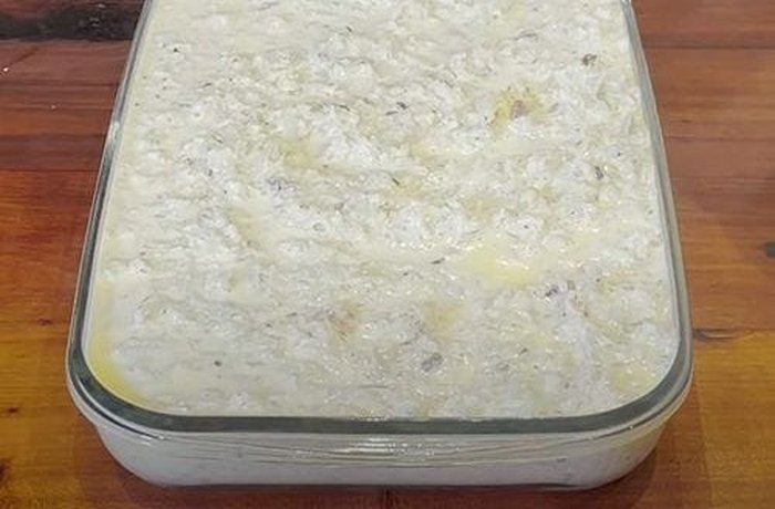 Cauliflower budin in the baking dish, covered with sliced mozzarella before going into the oven