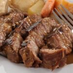 Chilean alpaca pot roast, braised meat in chili sauce served with mashed potatoes or rice