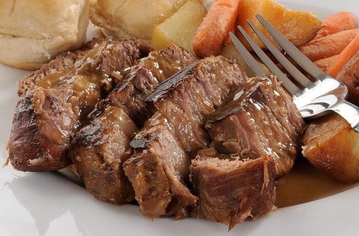 Chilean alpaca pot roast, braised meat in chili sauce served with mashed potatoes or rice