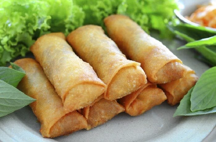 Fried Chilean arrollados de jamon y queso, served on a plate.