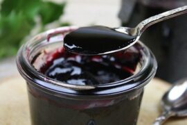 Bowl of Chilean arrope de uva, a thick dark grape syrup ready to be served over desserts