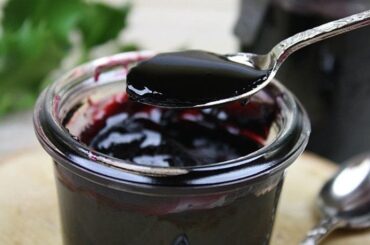 Bowl of Chilean arrope de uva, a thick dark grape syrup ready to be served over desserts