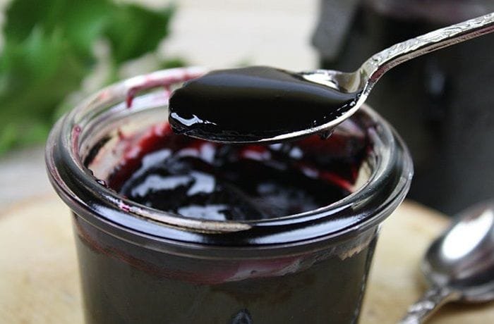 Bowl of Chilean arrope de uva, a thick dark grape syrup ready to be served over desserts