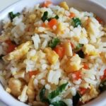 Homemade arroz chaufán with egg, turkey ham, and scallions