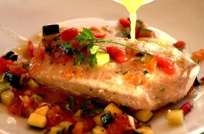 Chilean reineta fillets baked on a bed of vegetables