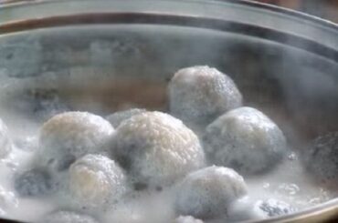 Chilean bolitas de indio, small potato dumplings served cold in sweet spiced milk in a dessert bowl