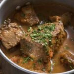 Cabrito a la olla: pieces of slow-cooked goat meat with new potatoes and parsley.