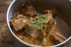 Cabrito a la olla: pieces of slow-cooked goat meat with new potatoes and parsley.