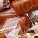 Homemade Chilean calugas, soft caramels cut and wrapped in wax paper