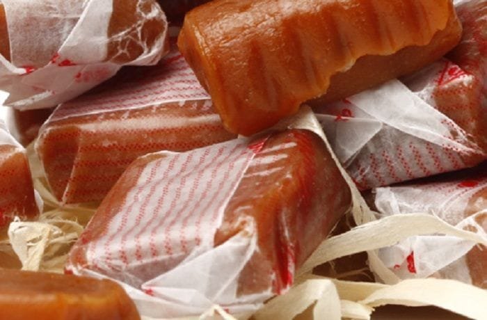 Homemade Chilean calugas, soft caramels cut and wrapped in wax paper