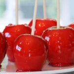 Homemade candy apples with shiny red caramel, perfect for children's parties