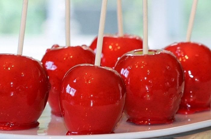 Homemade candy apples with shiny red caramel, perfect for children's parties