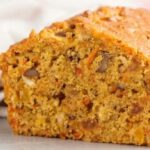Chilean carrot loaf cake with walnuts and raisins, dusted with powdered sugar
