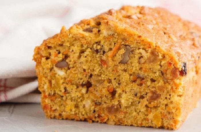 Chilean carrot loaf cake with walnuts and raisins, dusted with powdered sugar