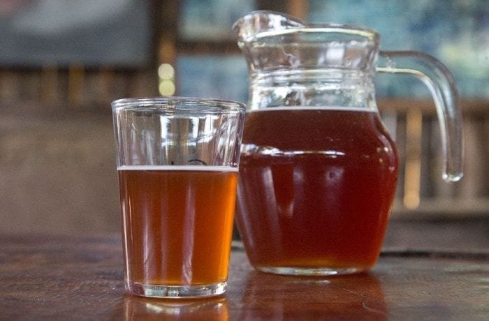 Chilean chicha de uva from Curacavi, a naturally fermented grape drink served in a glass pitcher.
