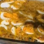 Chilean chicken feet head cheese with a firm jellied texture, carrot, cilantro, and visible pieces of hard-boiled egg