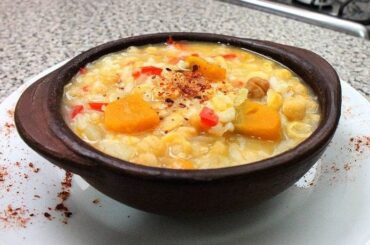 Chilean chickpeas with rice and squash in a clay bowl with merken