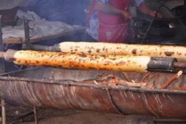 Chilean chochoca negra, rolled potato bread filled with pork cracklings, served hot.