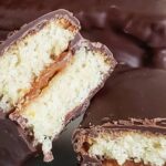 Rectangles of homemade Chilean chocman dipped in dark chocolate, with a visible manjar filling between the sponge layers.