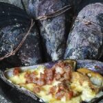 Chilean choritos al alicate, mussels sealed shut with wire, ready to be baked.