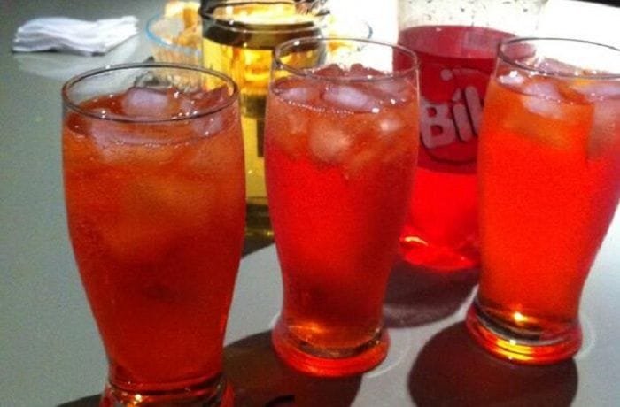 Chilean chuflay cocktail, aguardiente topped with soda in a tall glass with ice