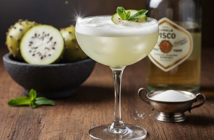 A chilled glass of Chilean copao sour cocktail made with desert cactus fruit and pisco.