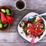 Chilean copihue salad with red petals, cherry tomatoes, mushrooms, and pumpkin seeds