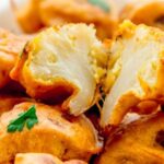 Homemade crispy Chilean cauliflower fritters served on a plate as a side