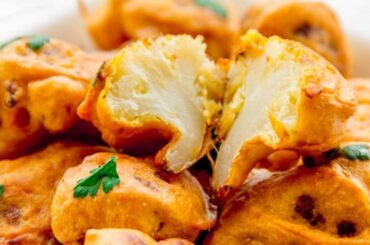 Homemade crispy Chilean cauliflower fritters served on a plate as a side