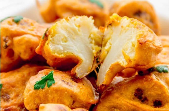 Homemade crispy Chilean cauliflower fritters served on a plate as a side