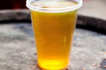 Chilean culen ponche served cold in a glass, a golden traditional herbal punch.