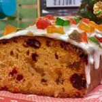 Chilean queque ingles, a loaf fruit cake with candied fruit, nuts, and raisins under a sugar glaze