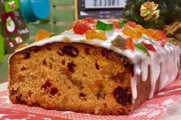 Chilean queque ingles, a loaf fruit cake with candied fruit, nuts, and raisins under a sugar glaze