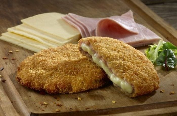 Chilean escalopa kaiser cut in half showing melted ham and cheese inside