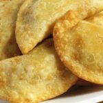 Chilean fried empanadas filled with chapes, a native limpet mollusk, served hot.
