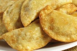 Chilean fried empanadas filled with chapes, a native limpet mollusk, served hot.