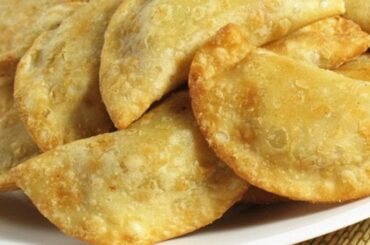 Chilean fried empanadas filled with chapes, a native limpet mollusk, served hot.