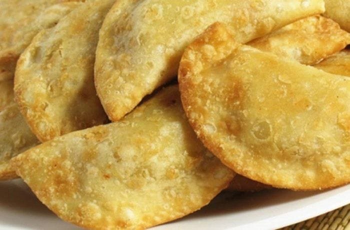 Chilean fried empanadas filled with chapes, a native limpet mollusk, served hot.