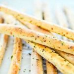 Homemade garlic and oregano breadsticks, a crisp bakery style appetizer