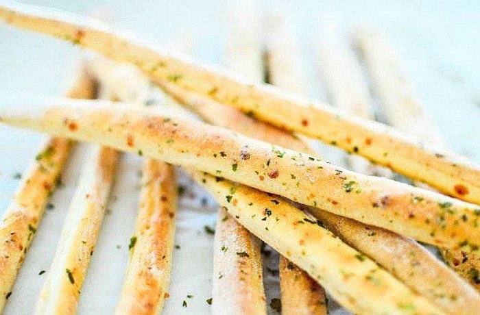 Homemade garlic and oregano breadsticks, a crisp bakery style appetizer
