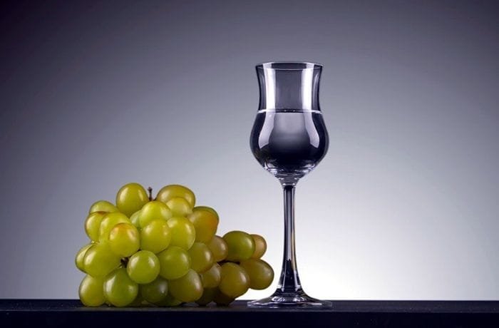 Chilean grape aguardiente, the clear spirit base used to macerate the berries.