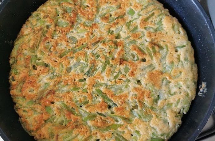 Chilean green bean tortilla with a golden surface served on a plate