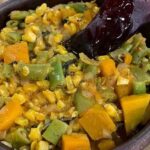 Chilean green bean stew, served hot with squash and fresh basil.