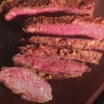 Chilean asado carnicero grilled over charcoal and sliced on a wooden board